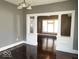 Bright living room with hardwood floors, classic archway and neutral paint at 2401 N Olney St, Indianapolis, IN 46218