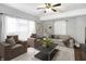 Cozy living room featuring stylish decor, a ceiling fan, and large windows for natural light at 2401 N Olney St, Indianapolis, IN 46218