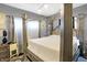 This is a bright main bedroom with a four-poster bed, grey walls, and natural light at 2401 N Olney St, Indianapolis, IN 46218
