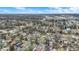 An overhead shot showcases a residential neighborhood with houses, streets and sparse trees and commercial buildings in the distance at 2402 Adams St, Indianapolis, IN 46218