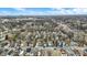 An elevated view of the residential area showcasing houses, streets and sparse trees under a sky with fair-weather clouds at 2402 Adams St, Indianapolis, IN 46218