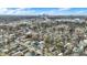 An elevated neighborhood view featuring homes, streets, and trees with the city skyline visible in the distance, blue sky above at 2402 Adams St, Indianapolis, IN 46218