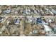 This aerial photo shows homes near a tree-lined road under a cloudy sky, creating a sense of place at 2402 Adams St, Indianapolis, IN 46218