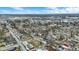 This aerial perspective features homes among trees, streets and buildings highlighting the neighborhood's amenities under a partly cloudy sky at 2402 Adams St, Indianapolis, IN 46218