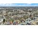 Overhead neighborhood shot with various home styles nestled among bare trees and snow-touched landscapes on a partly cloudy day at 2402 Adams St, Indianapolis, IN 46218