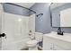 Well-lit bathroom features a vanity, mirror, toilet, and tub with a shower at 2402 Adams St, Indianapolis, IN 46218