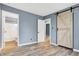 Bedroom with modern barn door and new flooring, plenty of light at 2402 Adams St, Indianapolis, IN 46218