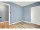 Bedroom features a closet, doorway, and wood-look flooring at 2402 Adams St, Indianapolis, IN 46218