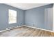 Bedroom with new flooring, and a large window providing natural light at 2402 Adams St, Indianapolis, IN 46218