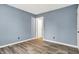 Bedroom featuring new flooring, light blue paint, and white trim at 2402 Adams St, Indianapolis, IN 46218