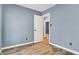 This bedroom features light wood floors and a doorway leading to the next room at 2402 Adams St, Indianapolis, IN 46218