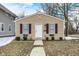 Charming tan-colored house with red shutters and a well-manicured lawn at 2402 Adams St, Indianapolis, IN 46218