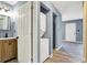 Hallway view featuring a laundry nook and bathroom with stylish vanity at 2402 Adams St, Indianapolis, IN 46218
