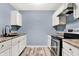 The cozy kitchen features a stainless steel oven, black sink, and clean, white cabinets at 2402 Adams St, Indianapolis, IN 46218