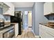 The cozy kitchen features stainless steel oven and clean, white cabinets at 2402 Adams St, Indianapolis, IN 46218