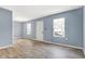 A cozy living room with light blue walls and wood-like floors, ready for your personal touch at 2402 Adams St, Indianapolis, IN 46218