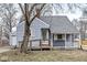 Charming single-Gathering home featuring a quaint front porch and blue siding with white trim at 2420 Sheffield Ave, Anderson, IN 46011