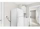 Modest kitchen with white cabinetry, appliances, and wood-look flooring at 2420 Sheffield Ave, Anderson, IN 46011