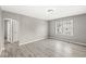 Bright living room with modern gray laminate flooring and a fresh coat of neutral paint at 2420 Sheffield Ave, Anderson, IN 46011