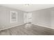 Open living room with durable laminate floors and view of the front entrance and the kitchen at 2420 Sheffield Ave, Anderson, IN 46011