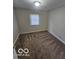 Room featuring carpeting, natural light from the window, and electrical outlets at 3209 Bethel Ave, Indianapolis, IN 46203