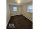 Bedroom with carpeted flooring and natural light from two windows at 3209 Bethel Ave, Indianapolis, IN 46203