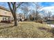 Lush backyard featuring a wooden deck, a covered pergola, and lake access at 3367 Redbud Ct, Westfield, IN 46074