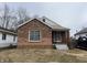 Charming brick home with a cozy front porch and well-maintained landscaping at 3451 Brouse Ave, Indianapolis, IN 46218