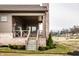 Back porch showcasing brick pillars and wood railings, set in a landscaped yard with new homes in the neighborhood at 3588 Marketplace Ct, Zionsville, IN 46077
