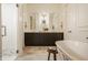 Bright bathroom with a stand-alone tub, custom vanity with double sinks, and a glass-enclosed shower at 3588 Marketplace Ct, Zionsville, IN 46077