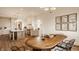 A beautifully designed dining room with a wood table, stylish chairs, and bright lighting adjacent to kitchen at 3588 Marketplace Ct, Zionsville, IN 46077