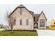 Beautiful brick home featuring an attached two car garage, arched front door, and manicured lawn at 3588 Marketplace Ct, Zionsville, IN 46077