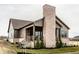 Two-story home featuring a covered porch, brick chimney, complemented by professionally landscaped grounds at 3588 Marketplace Ct, Zionsville, IN 46077