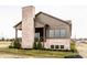 Exterior view of a two-story house with a brick chimney and covered porch, with new landscaping at 3588 Marketplace Ct, Zionsville, IN 46077