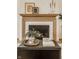 Close-up of a fireplace featuring a marble surround, wood mantle and modern decor at 3588 Marketplace Ct, Zionsville, IN 46077
