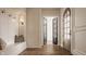 Inviting foyer with hardwood floors, arched doorways, and a built-in bench with storage, offering a warm welcome at 3588 Marketplace Ct, Zionsville, IN 46077