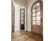 Grand foyer with arched doorways, hardwood floors, and a view to the exterior, creating a sense of openness at 3588 Marketplace Ct, Zionsville, IN 46077