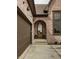 Arched front door with glass panes framed by brick and sconce lighting for a charming curb appeal at 3588 Marketplace Ct, Zionsville, IN 46077