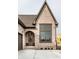 Arched front door with glass panes framed by brick and next to a large window at 3588 Marketplace Ct, Zionsville, IN 46077