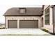Elegant two-car garage featuring brown doors and brick exterior, creating a sophisticated curb appeal at 3588 Marketplace Ct, Zionsville, IN 46077