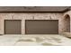 Attached two car garage with raised panel doors and charming sconce lighting near the arched entry at 3588 Marketplace Ct, Zionsville, IN 46077