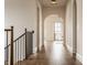 Hallway showcasing hardwood floors, archways, and a staircase, combining functionality with elegant design elements at 3588 Marketplace Ct, Zionsville, IN 46077