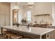 Bright kitchen featuring marble countertops, pendant lighting, and a large island with seating at 3588 Marketplace Ct, Zionsville, IN 46077