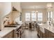 Modern kitchen with a stainless steel range, large island, and hardwood flooring at 3588 Marketplace Ct, Zionsville, IN 46077