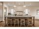 Bright kitchen with a large island, modern pendant lights, and stainless steel appliances, blending style with functionality at 3588 Marketplace Ct, Zionsville, IN 46077