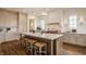 Stylish kitchen with a large island, marble countertops, custom cabinetry, and modern lighting, creating a luxurious space at 3588 Marketplace Ct, Zionsville, IN 46077