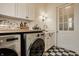 Charming laundry room with white cabinets, marble counters, and stainless steel washer and dryer at 3588 Marketplace Ct, Zionsville, IN 46077