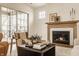 A cozy living room showcasing a fireplace with marble surround, comfortable seating, and natural light at 3588 Marketplace Ct, Zionsville, IN 46077