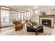 A beautifully decorated living room featuring a fireplace, comfortable seating, and sliding doors at 3588 Marketplace Ct, Zionsville, IN 46077