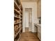 Walk-in pantry features custom cabinetry, a marble countertop, and hardwood floors throughout the space at 3588 Marketplace Ct, Zionsville, IN 46077